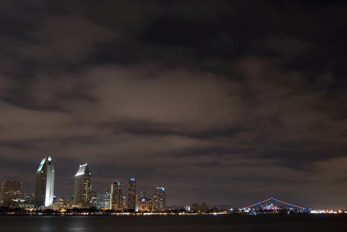city buildings near body of water metropolis