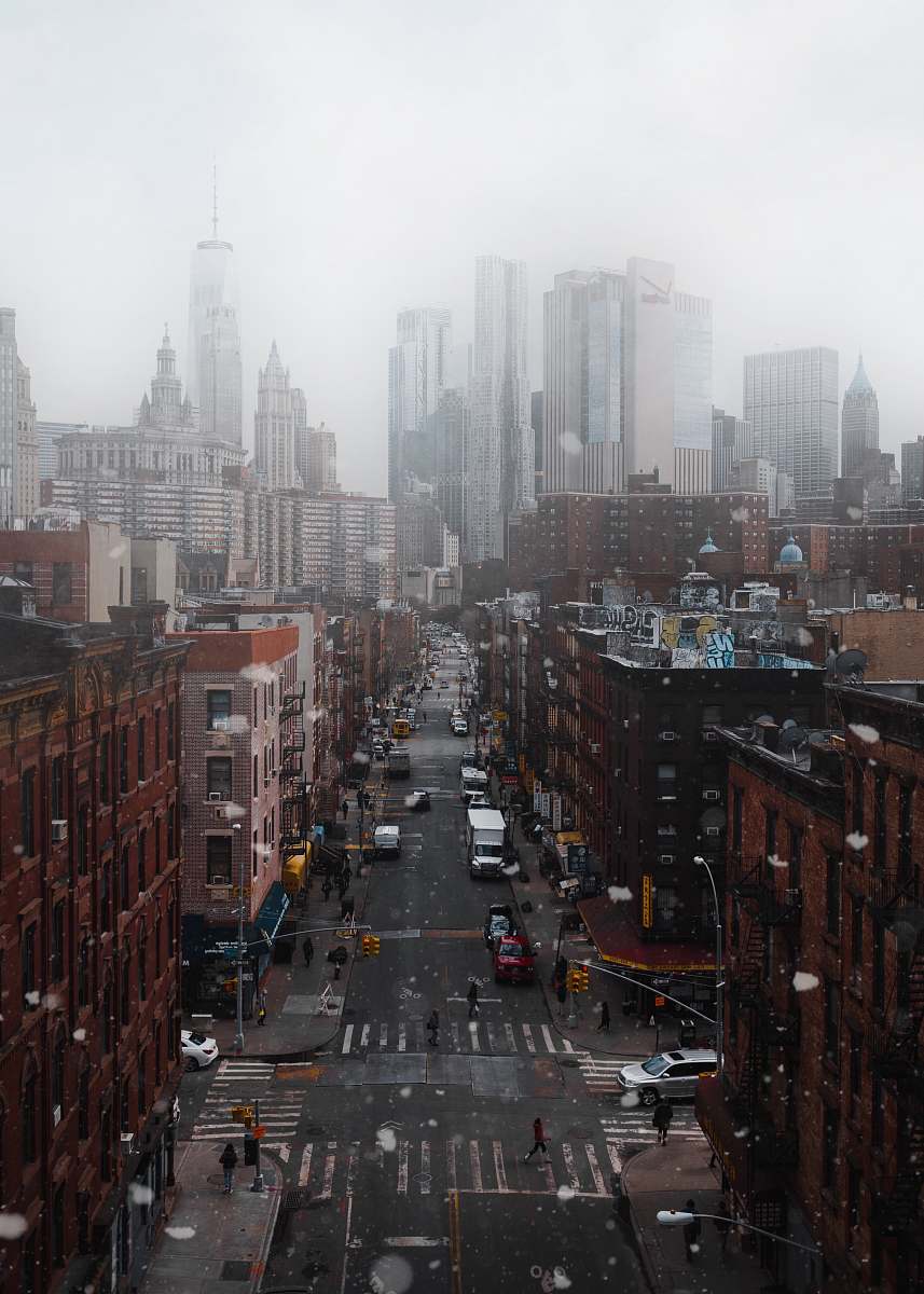 city cars parked between buildings under cloudy sky at daytime urban