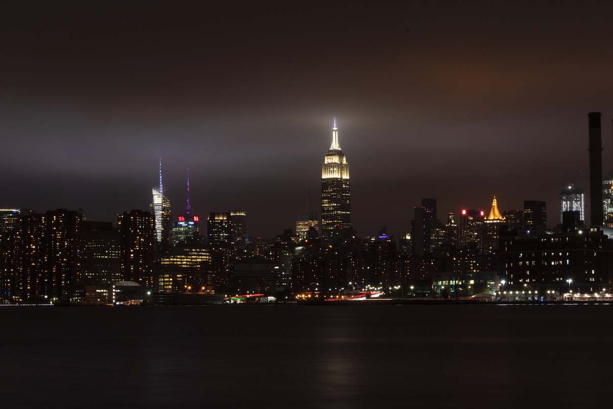 city city buildings under gray sky during nighttime downtown