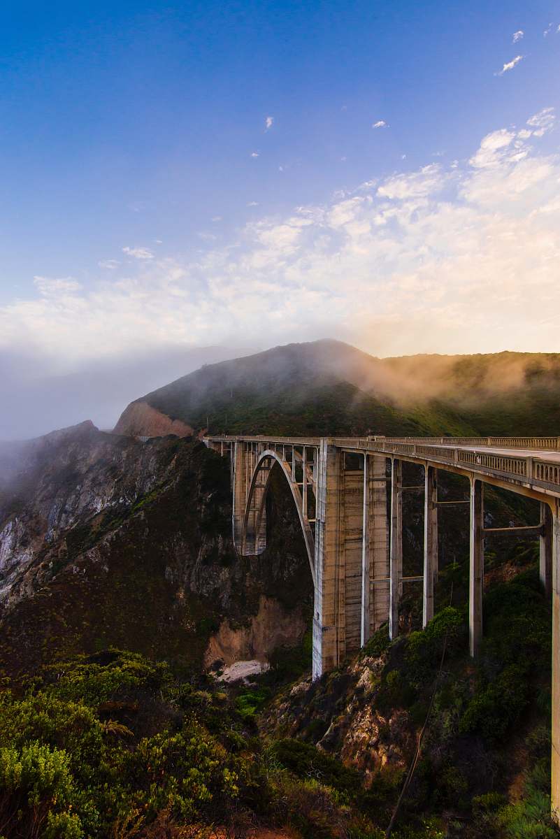 bridge gray concrete bridge over green mountains during daytime architecture