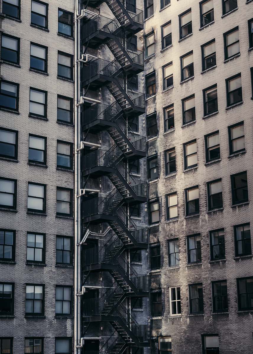 city gray concrete buildings with metal exit stairs urban