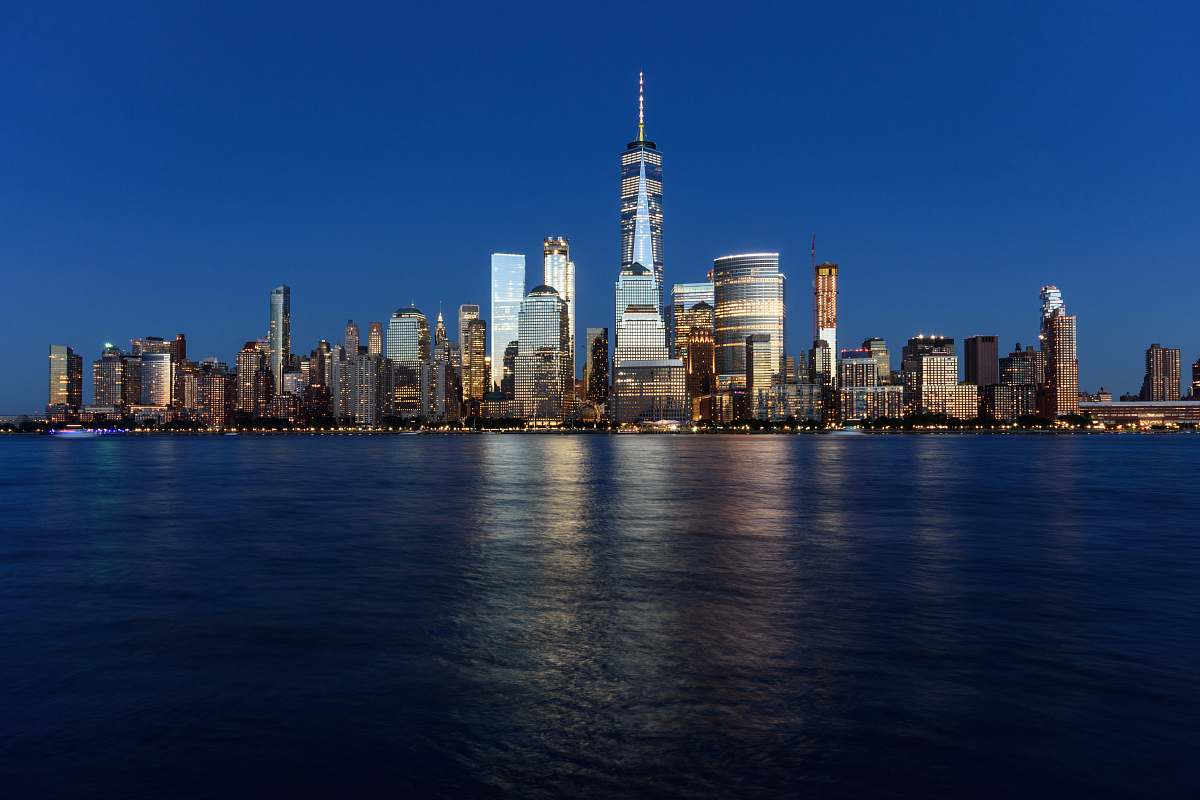 city landscape shot of buildings surrounded body of water urban