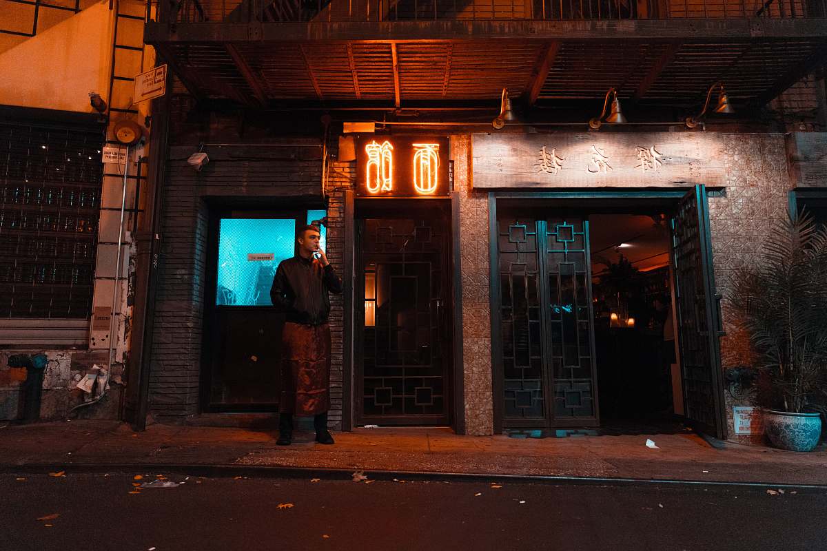 chinatown man standing near house during night new york