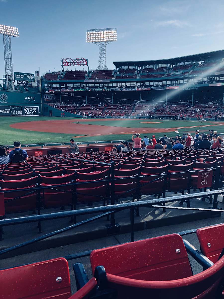 human people sitting inside baseball arena during daytime person