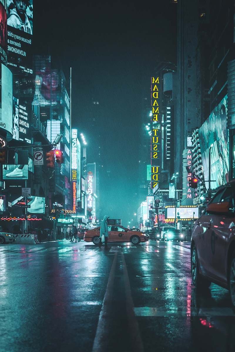 city person in grey raincoat and orange car crossing the intersection urban