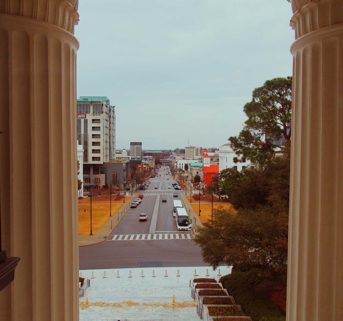 road vehicles on street between buildings view from window architecture