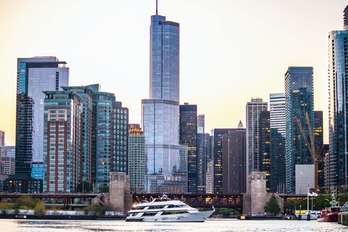 city white yacht near dock high rise