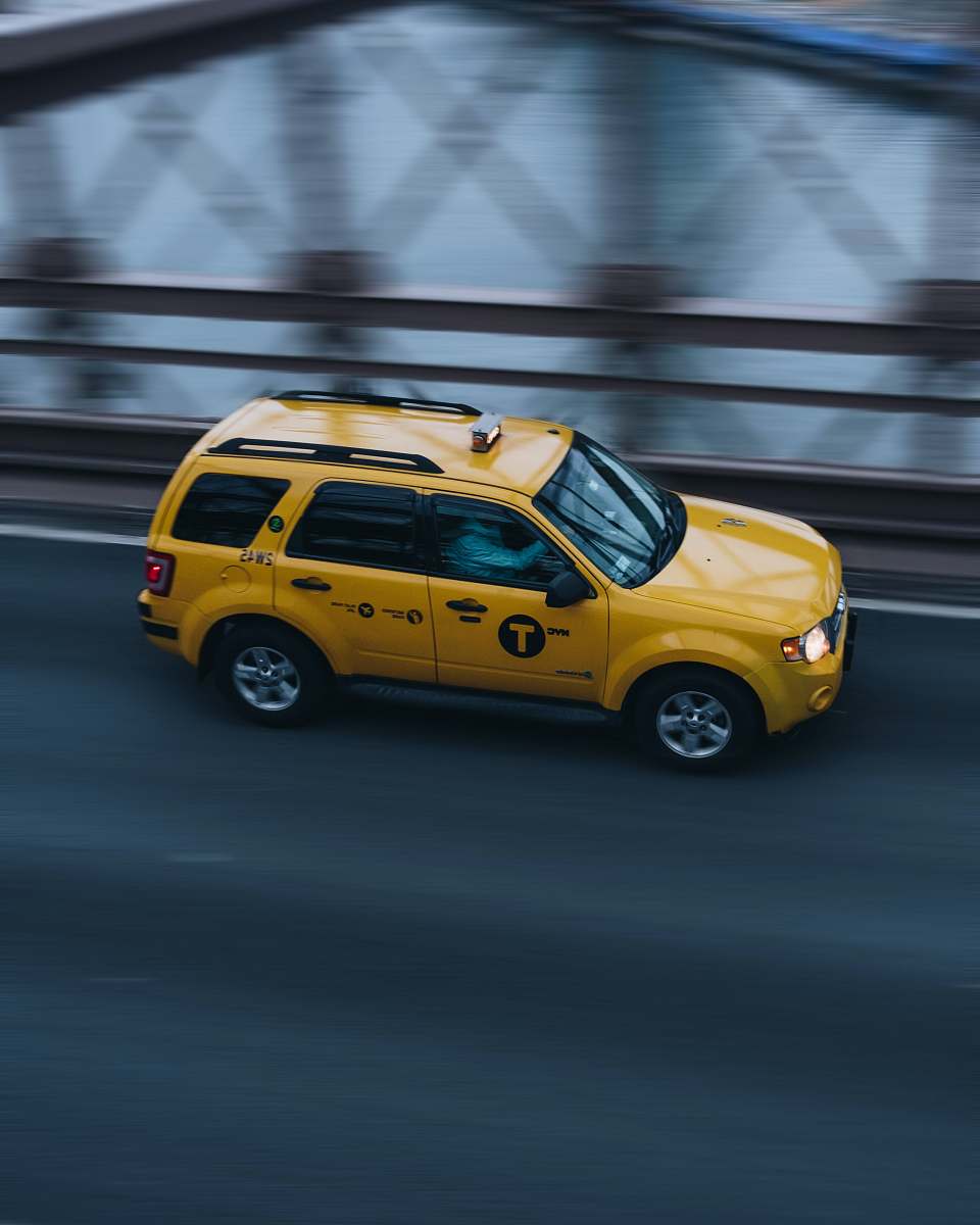 car time lapse photo of yellow SUV on road vehicle