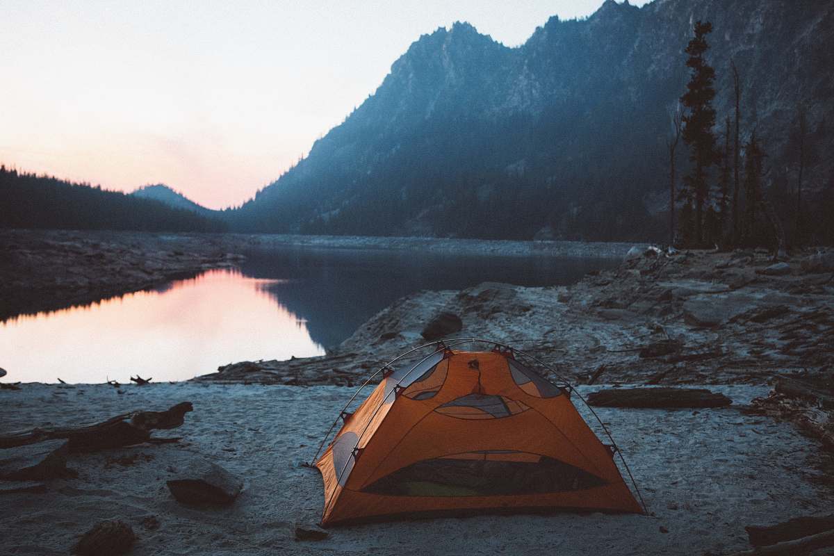 tent orange and gray camping tent near body of water leisure activities