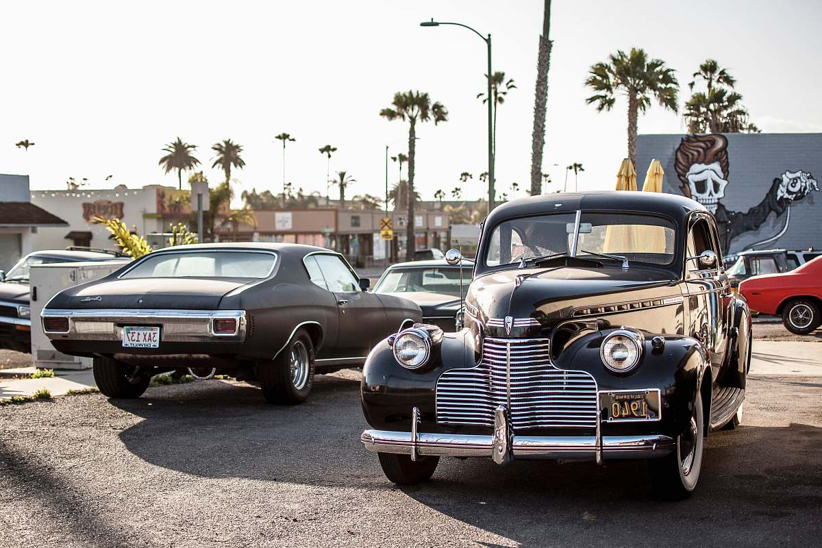 automobile black car beside car during daytime vehicle