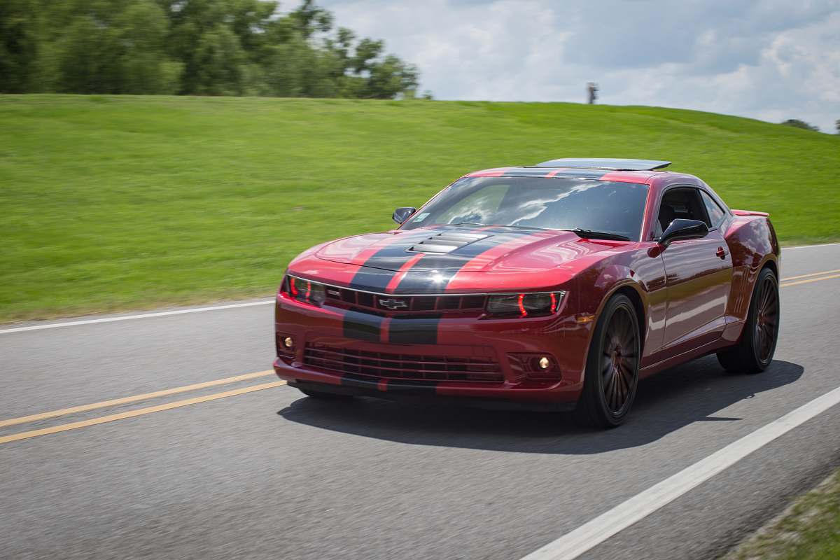 automobile red and black Chevrolet coupe on roadway transportation