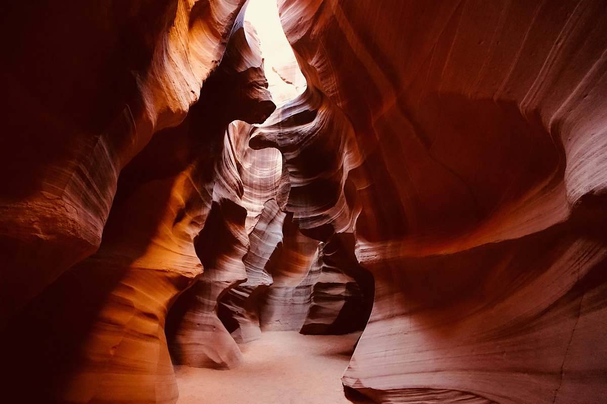 nature brown cave during daytime human