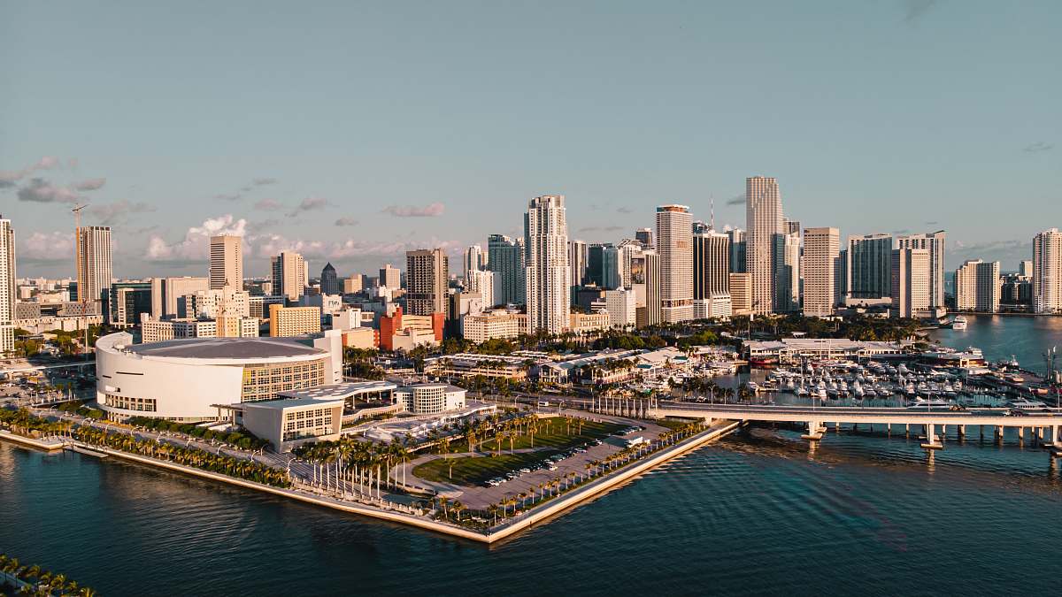 building city skyline between sky and body of water town