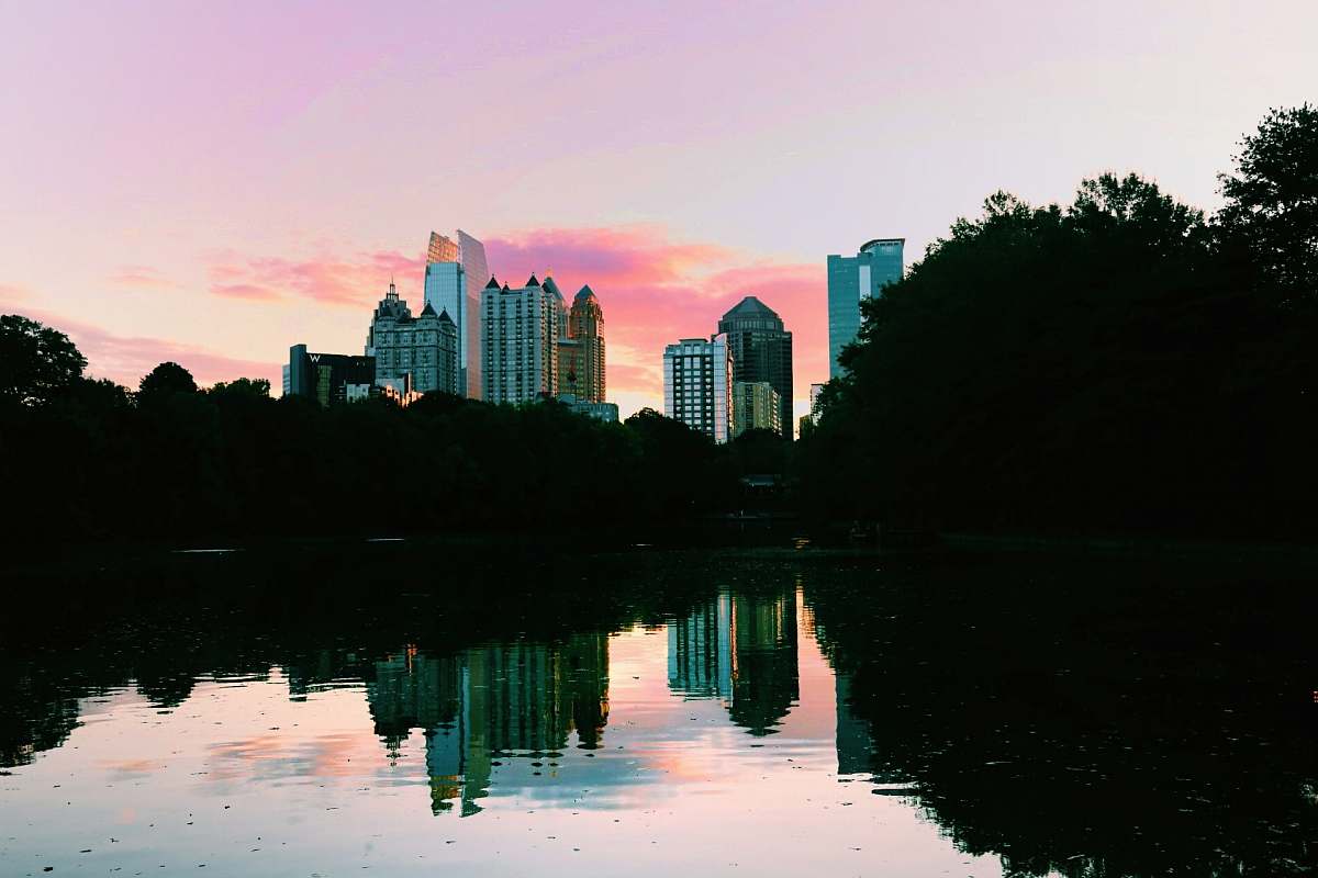 atlanta high rise building across body of water sunset