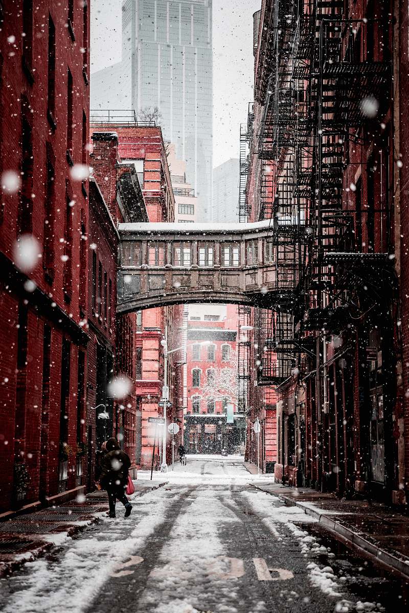 building person walking on the street during daytime street