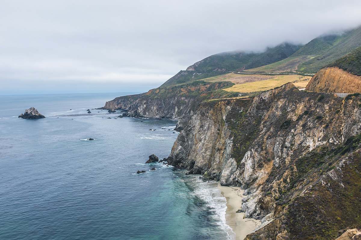 outdoors aerial photography of mountain beside body of water promontory