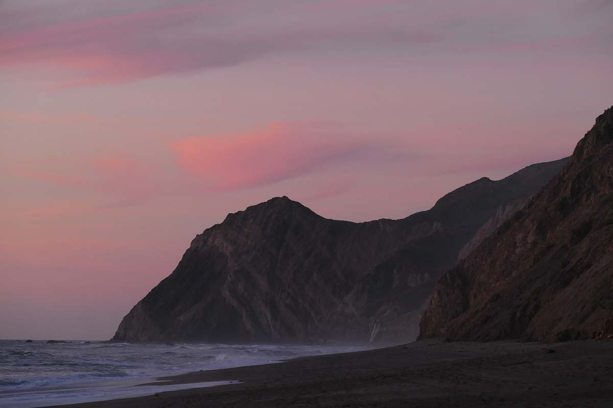 ocean mountain beside body of water coast
