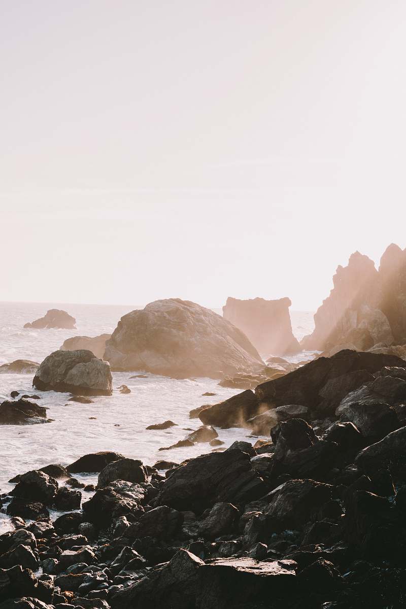 nature black rock formation near body of water ocean