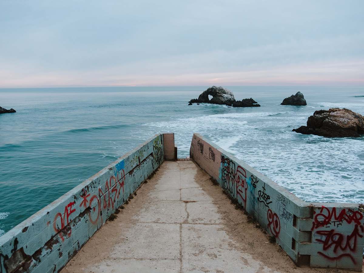ocean concrete dock with graffiti sea
