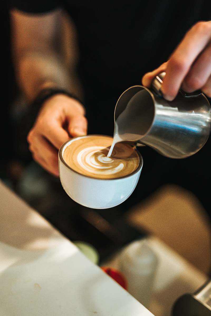 cup person preparing latte with art coffee cup