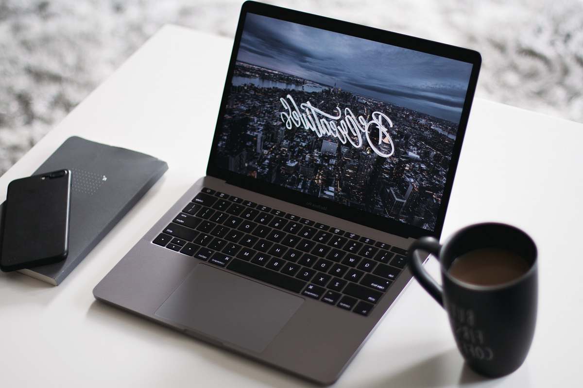 laptop black and gray laptop computer beside black ceramic mug pc