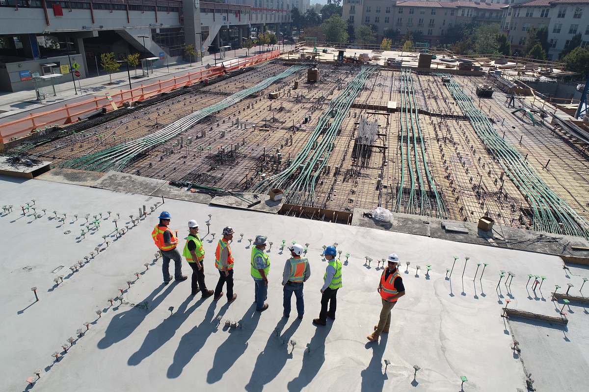 human seven construction workers standing on white field person