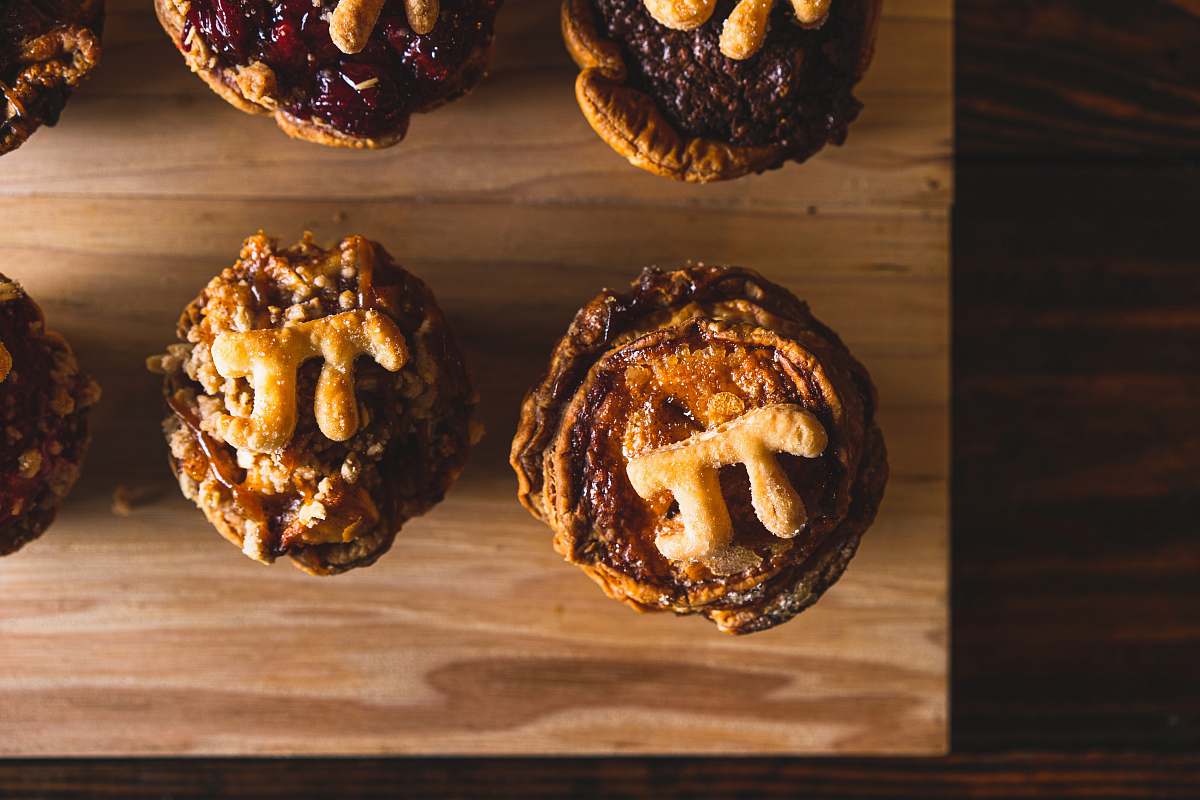 food brown and black cupcakes on brown wooden table bread