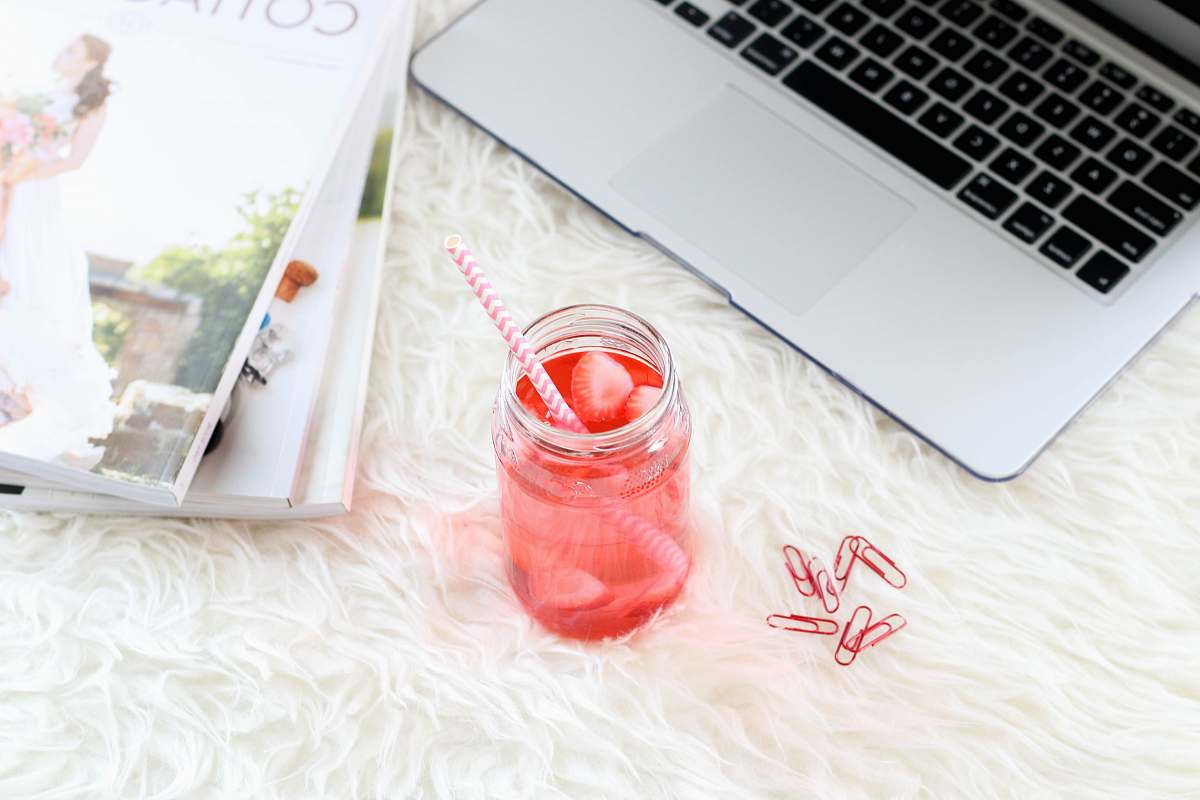 work clear mason jar with red liquid and straw new york