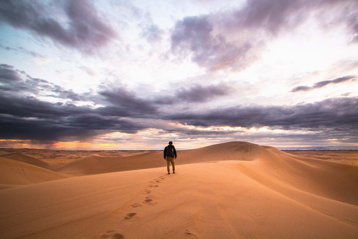 sand man walking on desert glamis