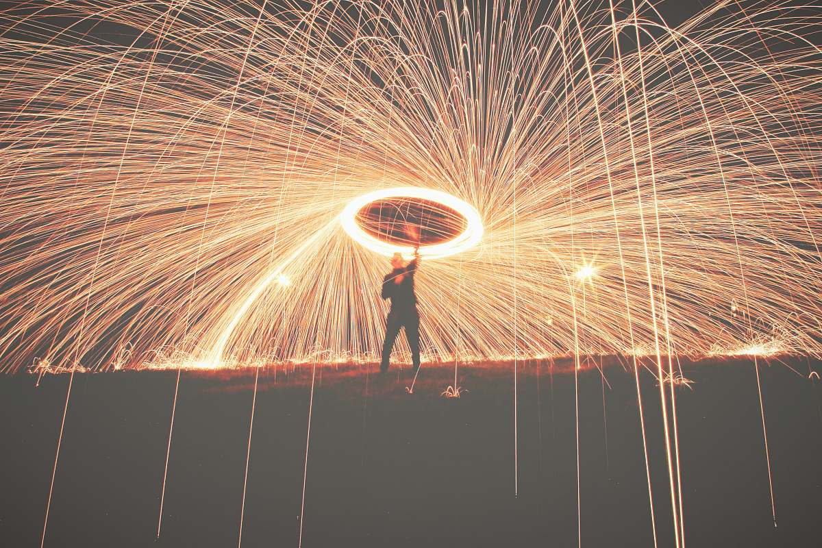 night man holding fireworks outdoors