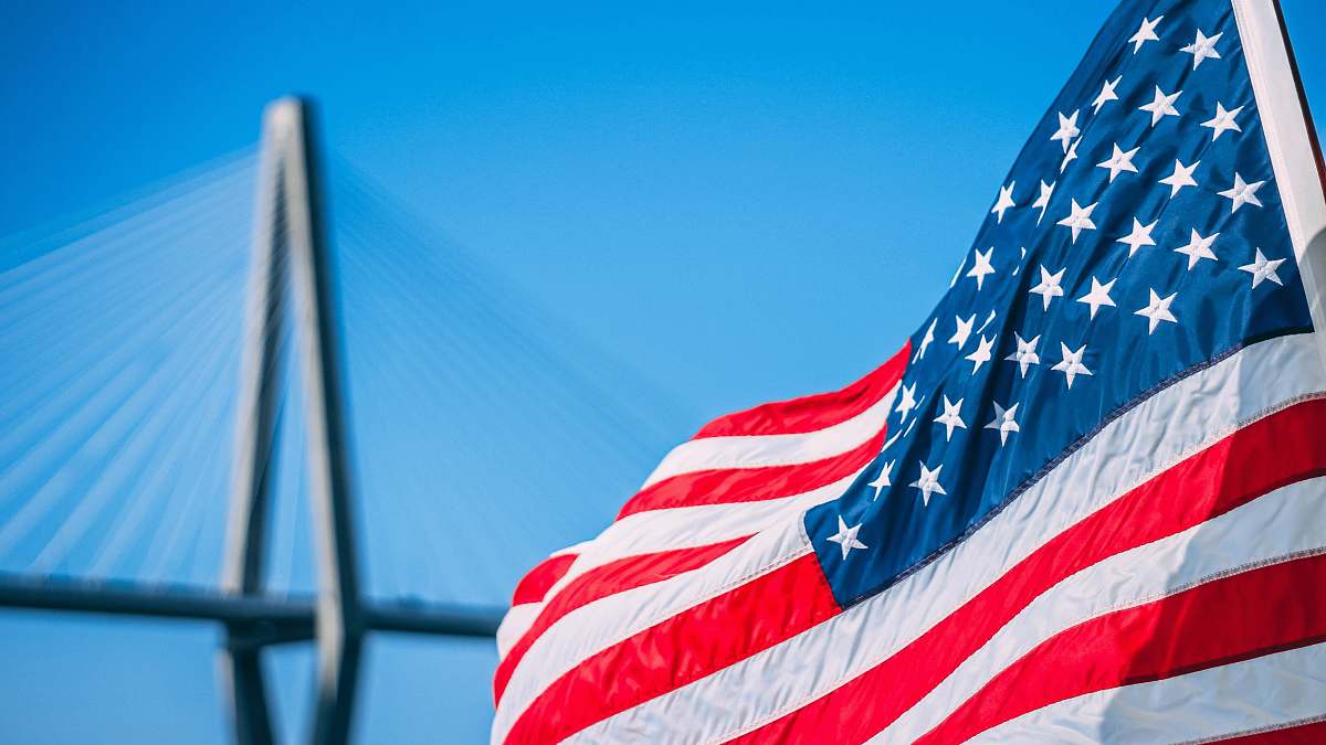 symbol us a flag on pole during daytime charleston