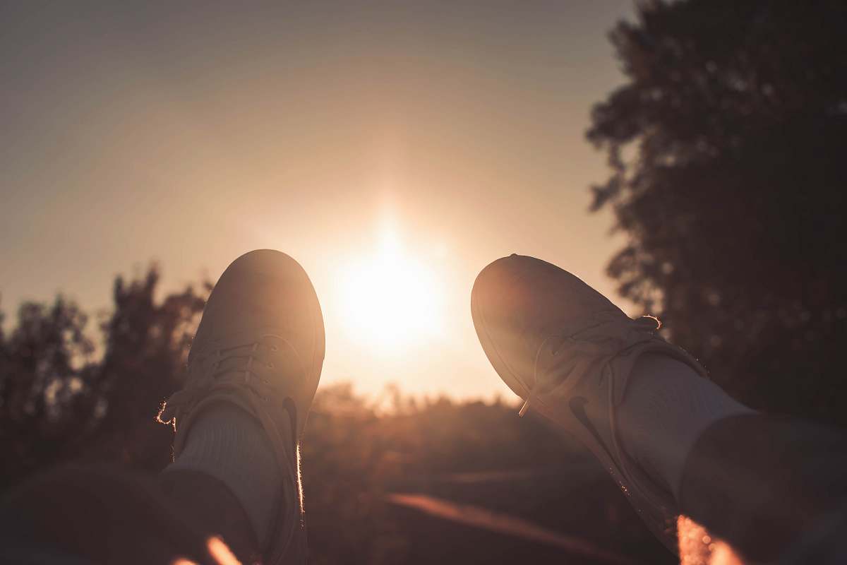 light person wearing white Nike lace-up sneakers during golden hour lake oswego