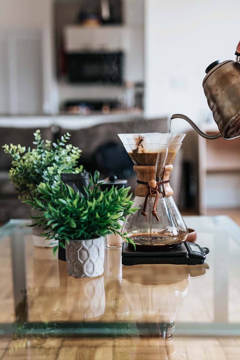 plant person pouring coffee ion jar coffee