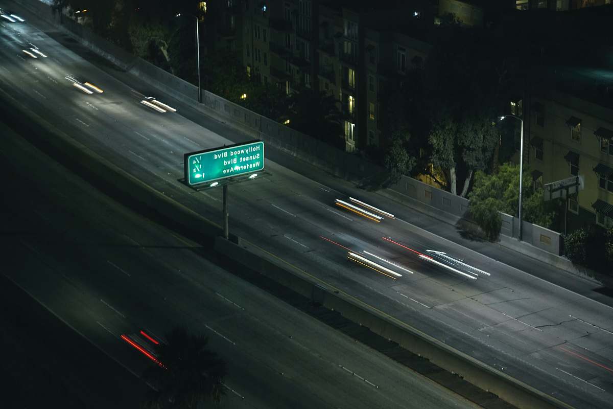 freeway time lapse photo of vehicle on road road