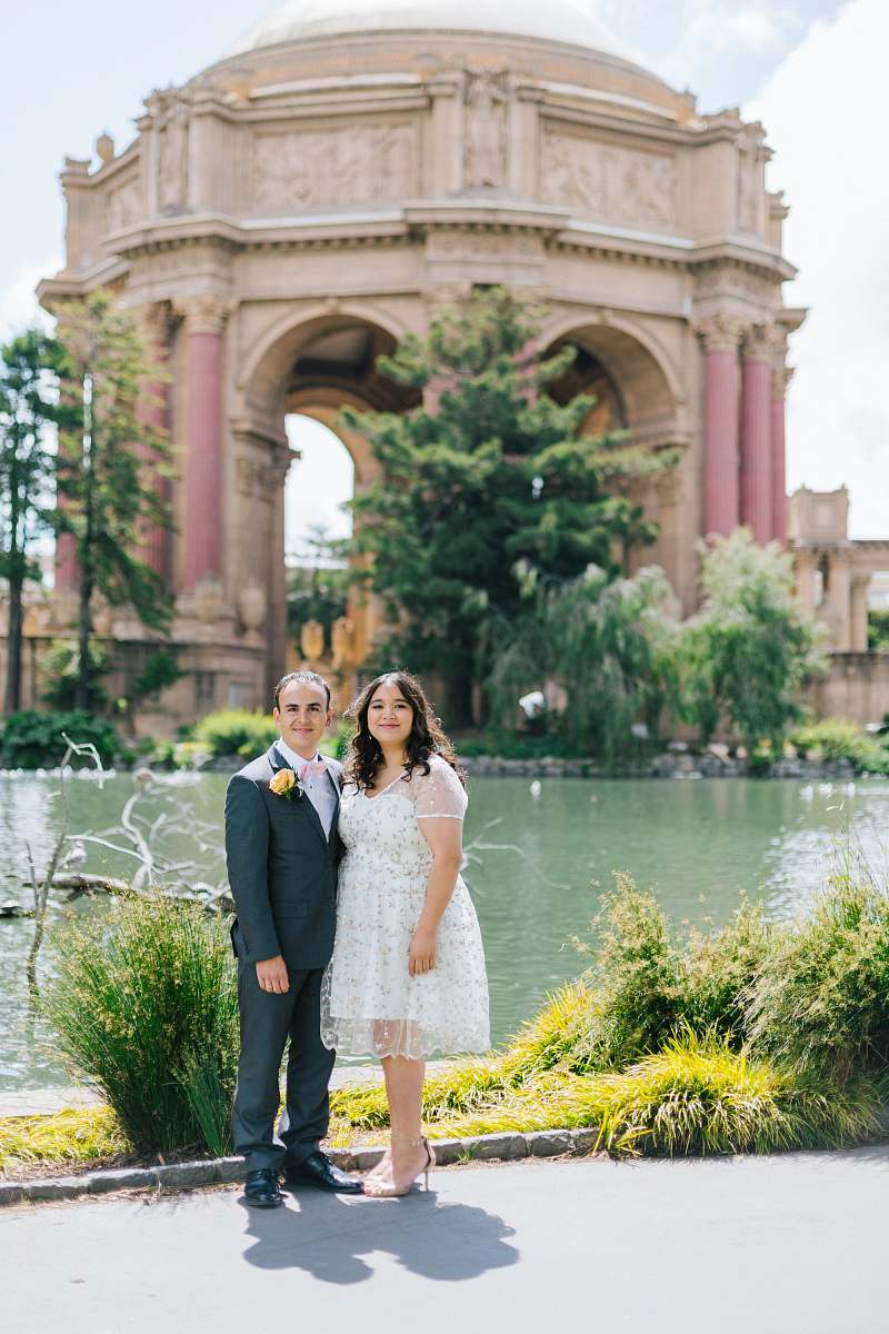 plant woman and man standing beside body of water jar
