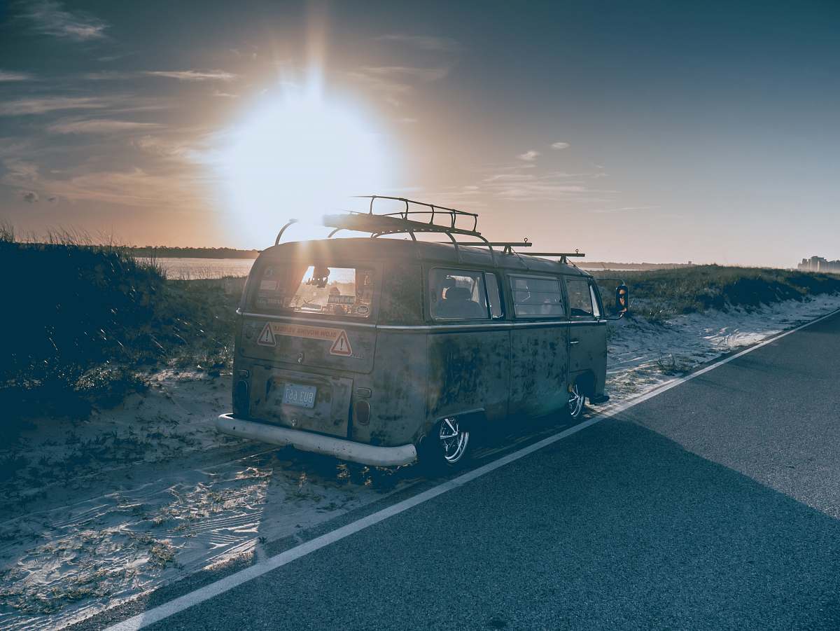 van gray van parked beside road during daytime vehicle