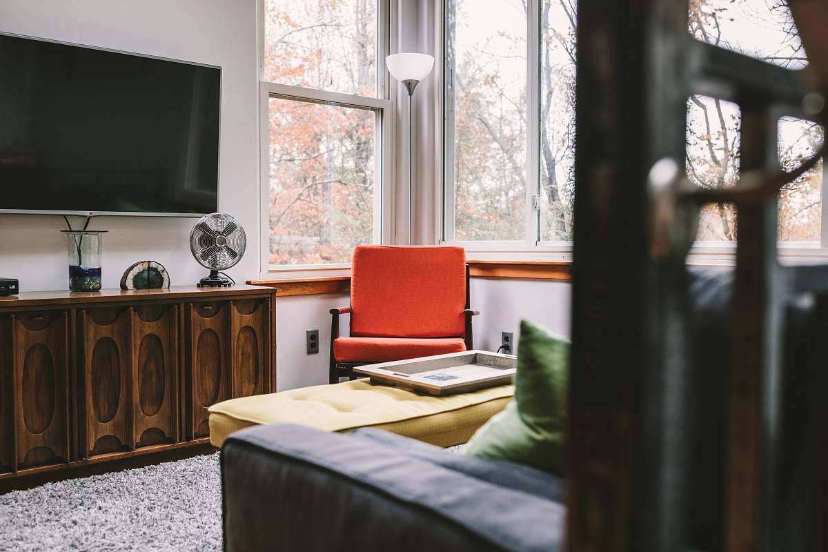 sideboard flat screen TV on white wall inside room bed