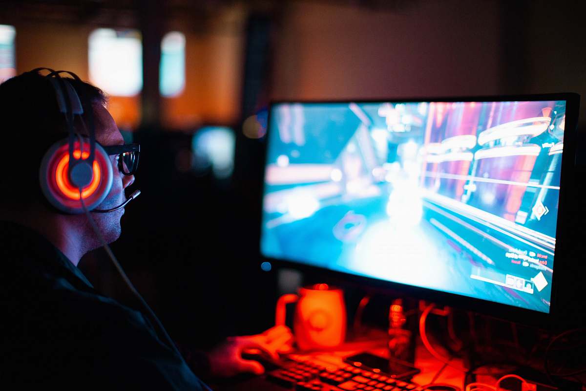 game person using computer playing FPS game gamer