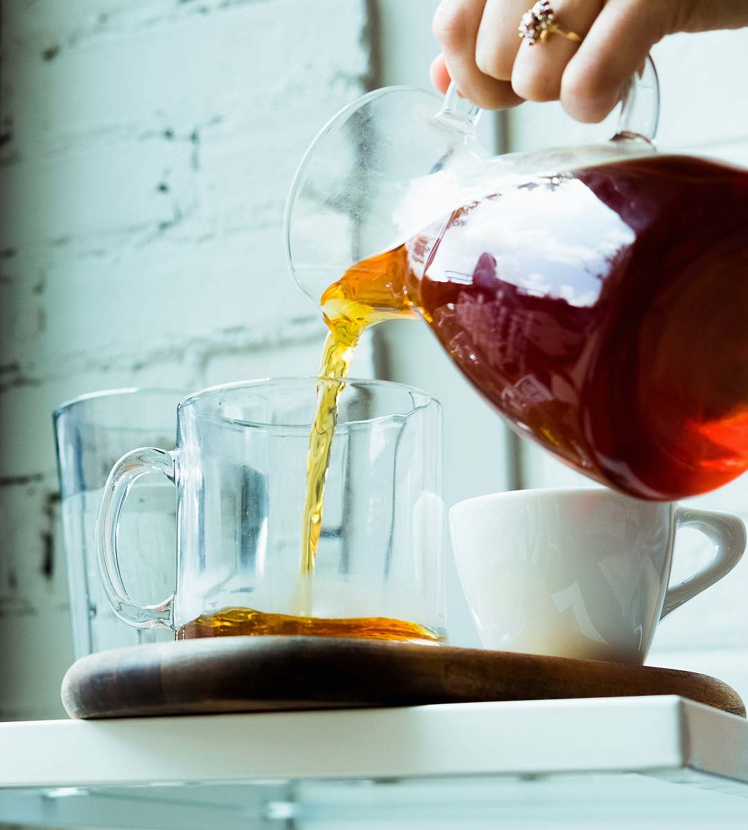 tea person pouring tea on cup cup