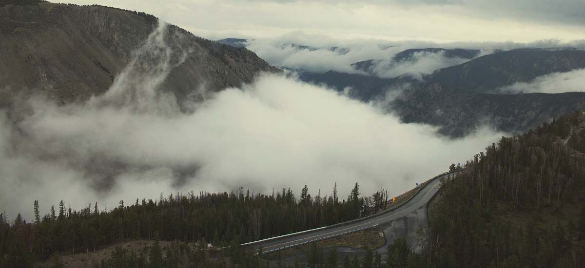 mountain aerial photo of road and mountains with white fogs at daytime beartooth highway