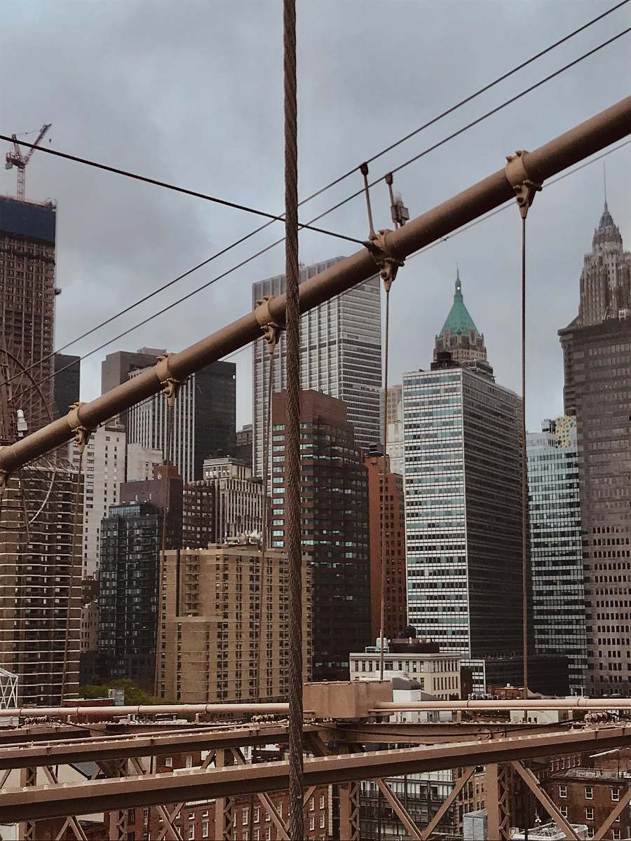 building brown and white concrete buildings under white clouds during daytime banister