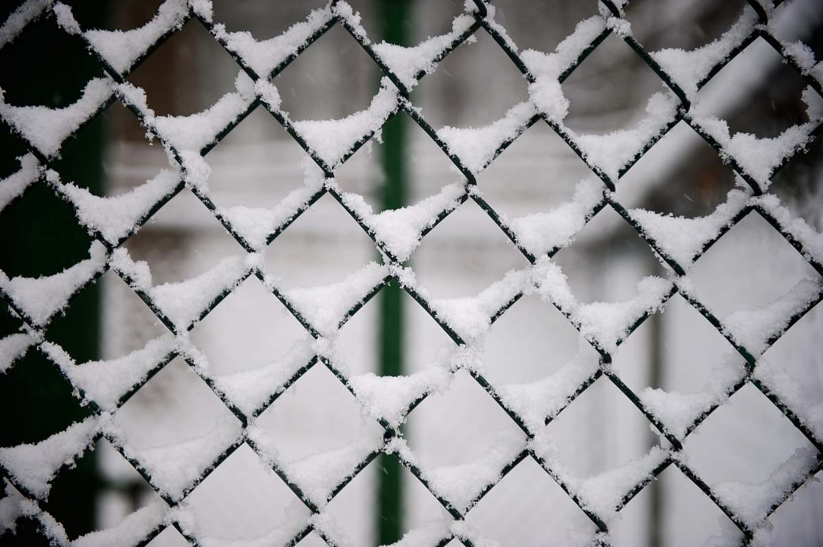 outdoors snow covered black steel fence snow