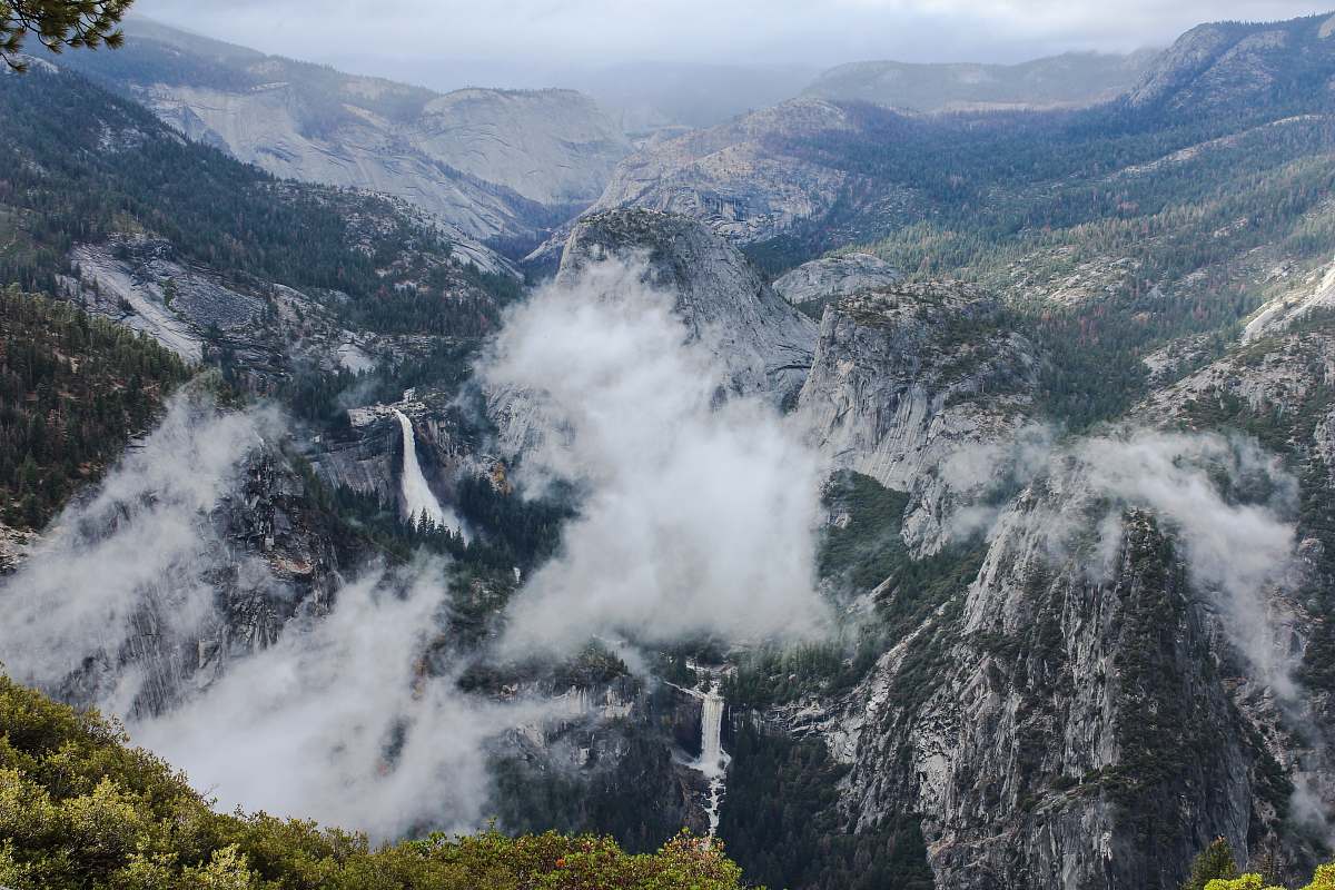 mountain top view of mountain covered with fogs crest