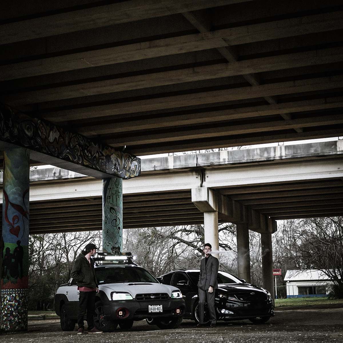 freeway two man standing near cars downtown