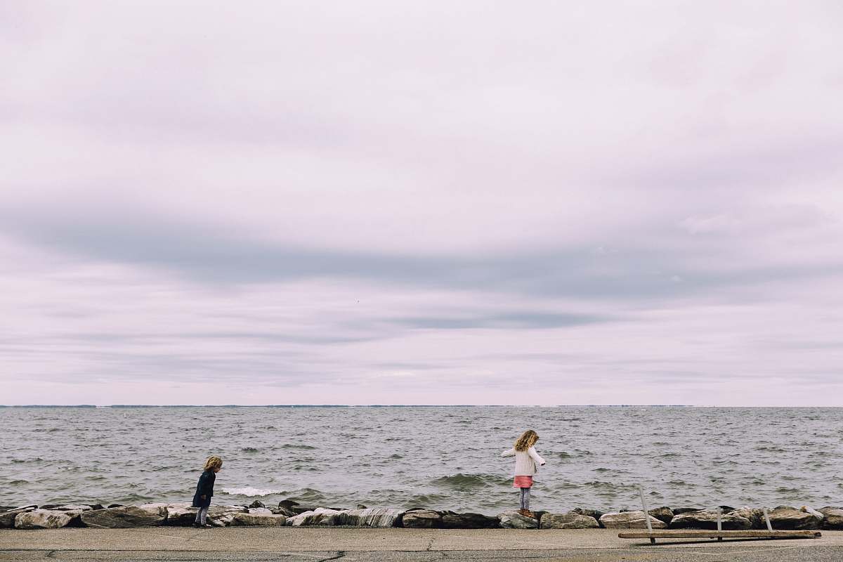 annapolis woman standing on cliff beside body of water coast
