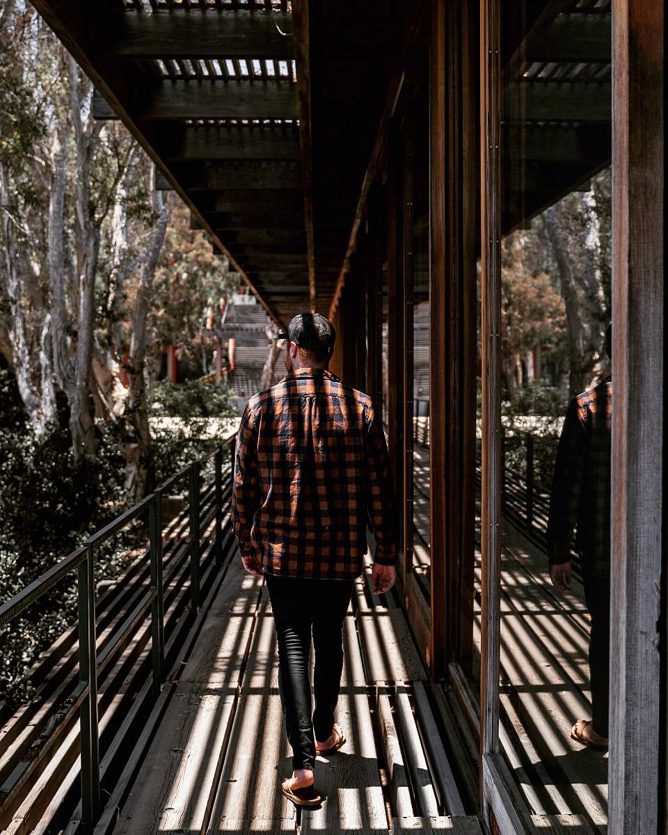 banister man wearing brown and black plaid long-sleeved shirt human