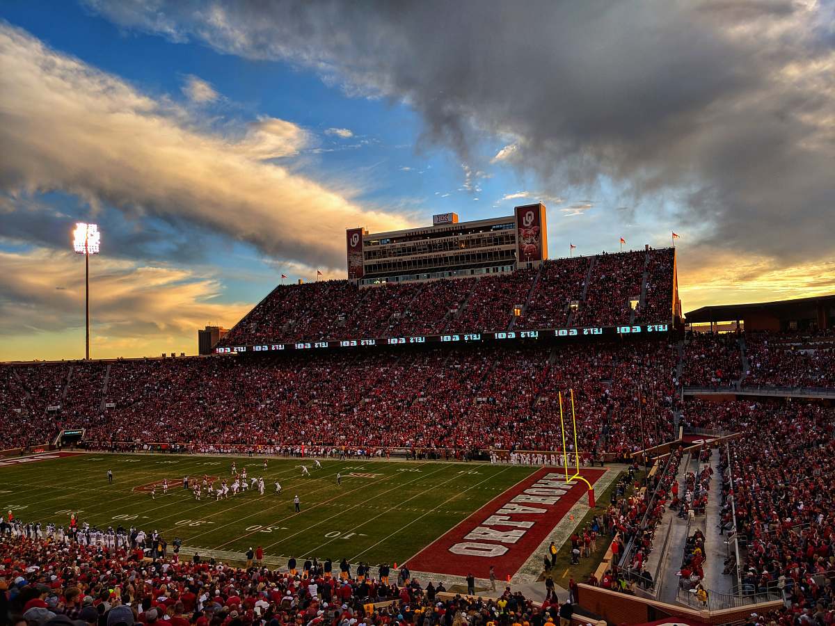 Experience the electrifying atmosphere of a football stadium captured in stunning architectural photography. This general view showcases enthusiastic fans celebrating during a game, highlighting the vibrant energy and architectural marvel of the stadium. Perfect for sports magazines, event promotions, or any content focusing on sports architecture and fan experiences.
