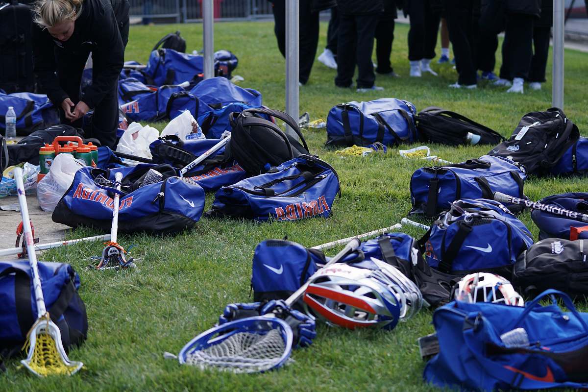 person bagas and rackets on the grass people