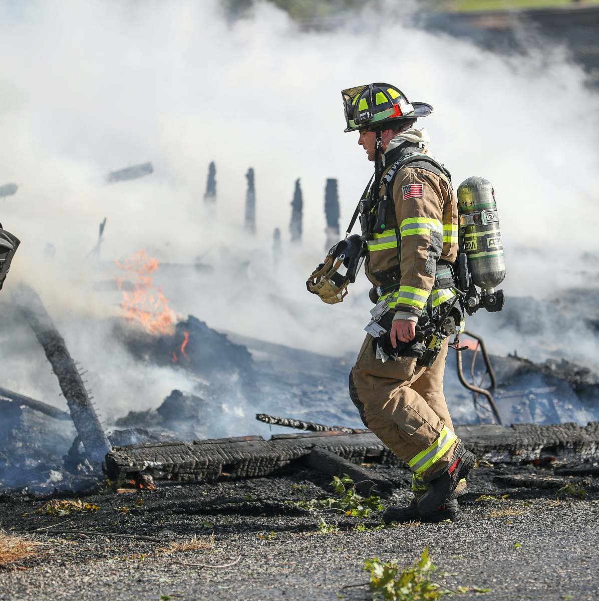 person firefighter watching of burning plank fireman