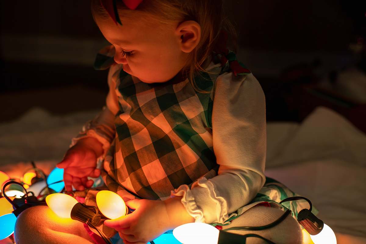 person girl holding string lights pascagoula